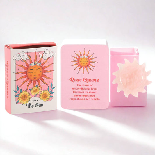 Rose Quartz stone in a pink box with sun design and text on a white background