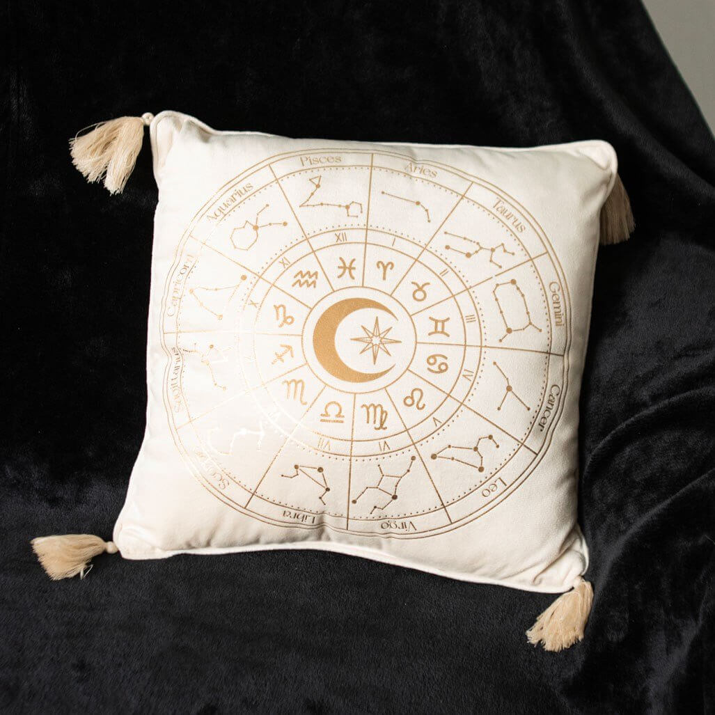 Decorative pillow with zodiac design on a black background